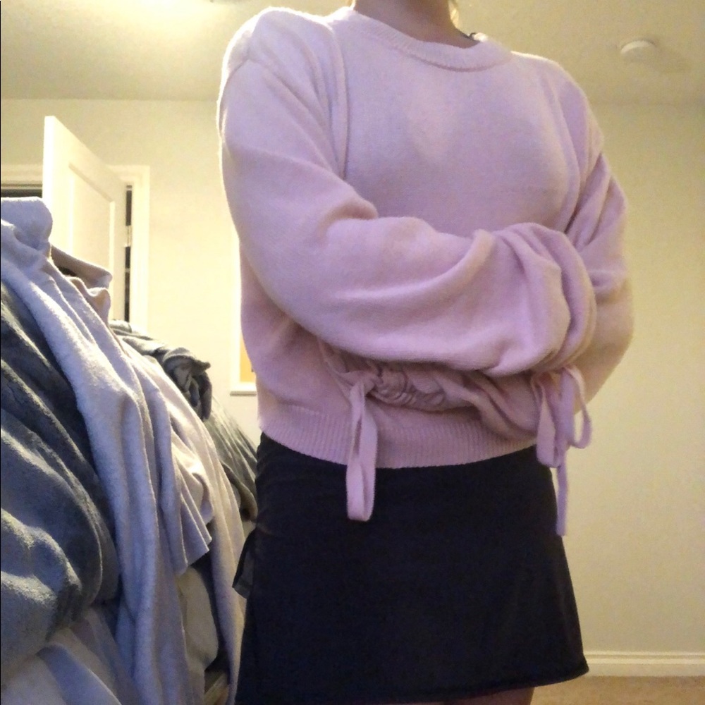 A cute pink sweater that can fit small or medium
